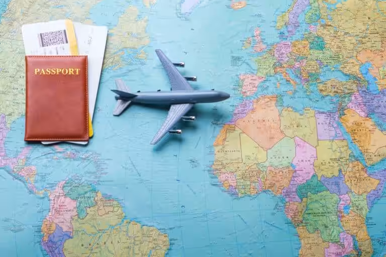 Passport and flight tickets placed on a world map – symbolizing travel planning and wanderlust.
