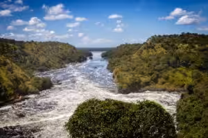Wide river with rapids flowing between green hills in a tropical landscape