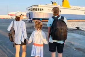 Family arriving at ferry port with luggage preparing for island travel in the Philippines