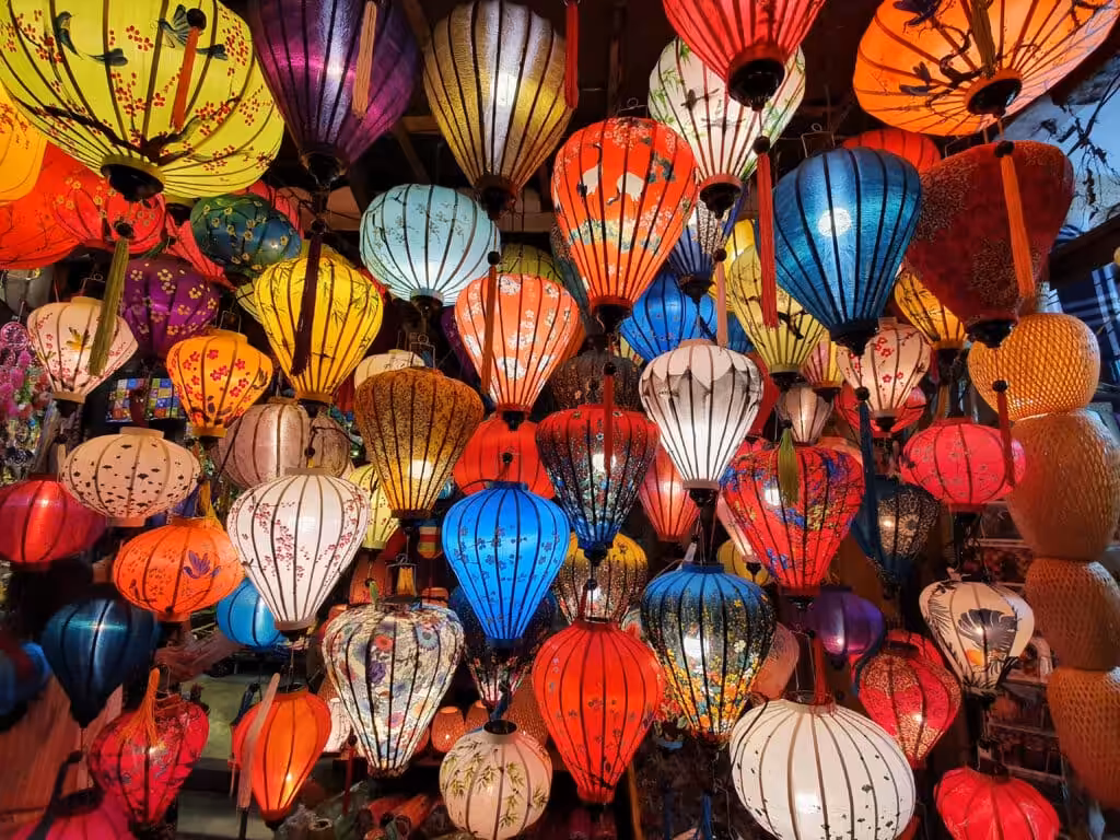 Colorful silk lanterns hanging densely at a shop in Hoi An, Vietnam