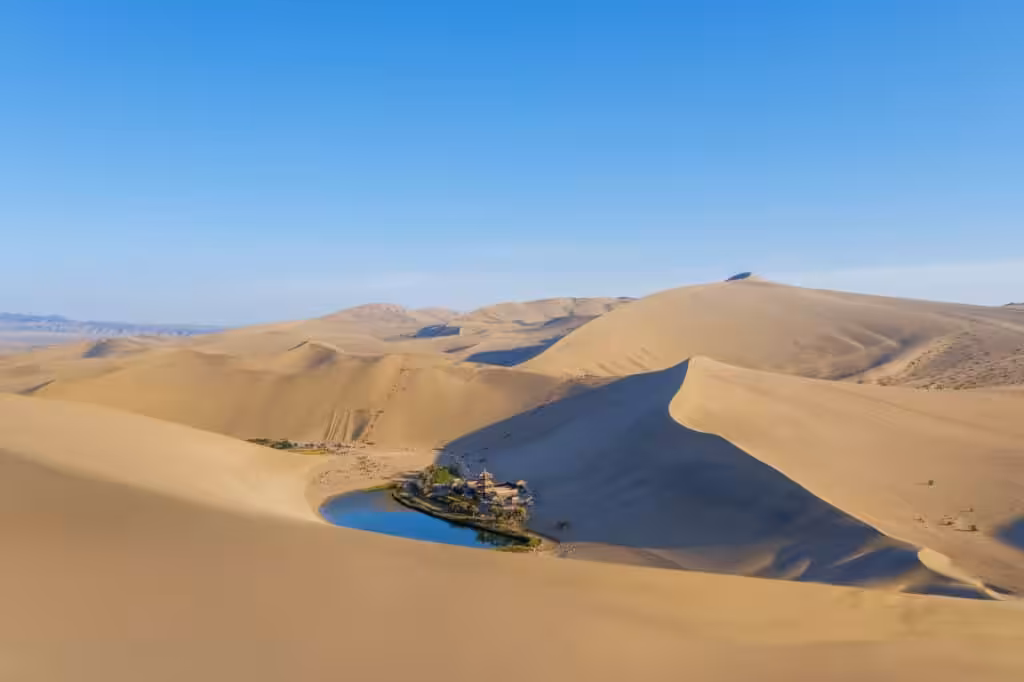 Crescent Lake oasis surrounded by the Singing Sand Dunes near Dunhuang, Gansu Province, China