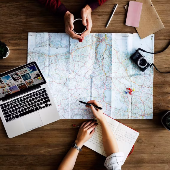 Travellers planning a route together on a map.